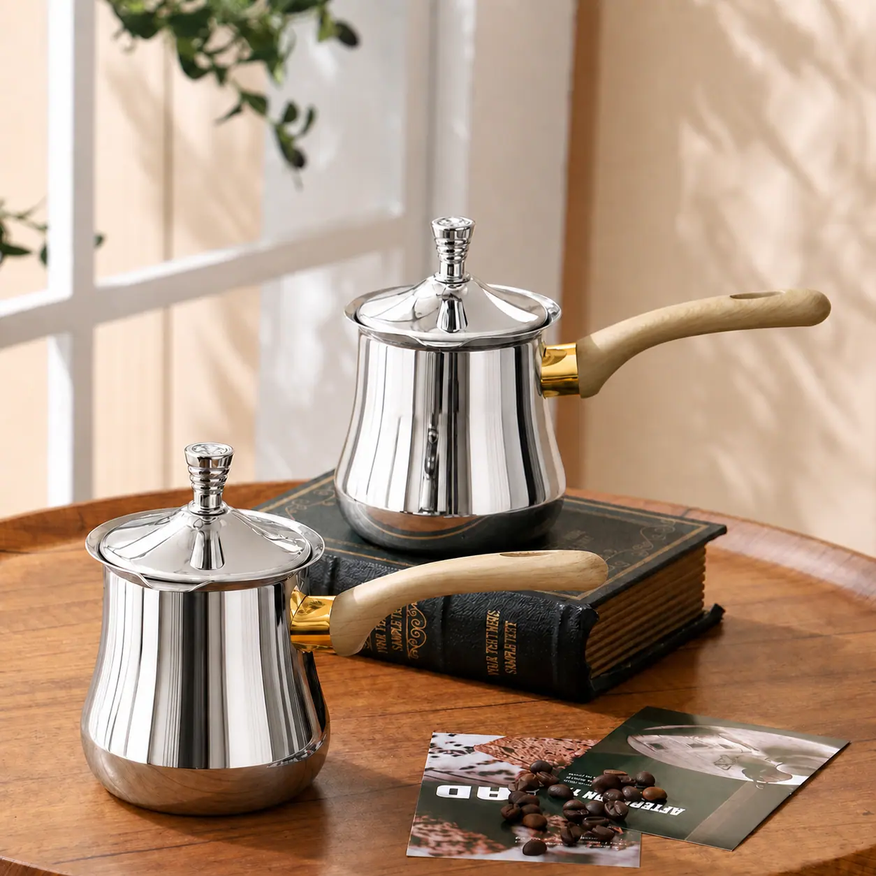 Undecorated polished stainless steel coffee pots with light wood handles
